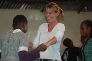 Mathare Valley slum school, Brenda being shown how to dance